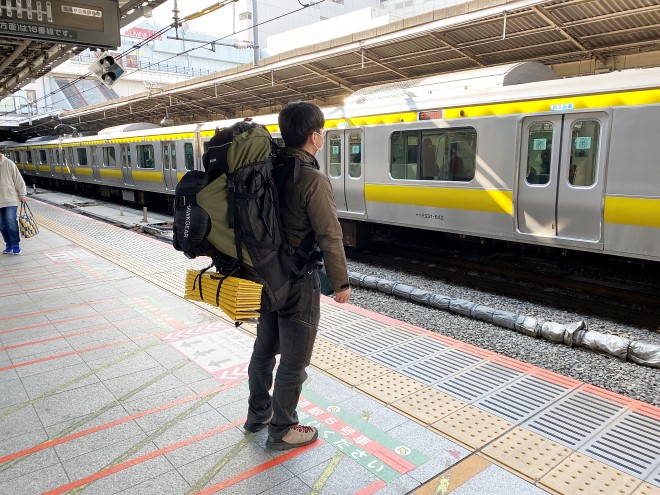 新宿駅ホームで電車を待つ編集部員